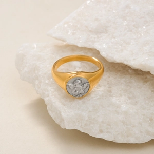Detailed view of an 18k gold plated sun ring with a silver cupid angel relief on stone