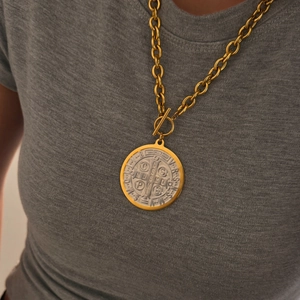 Detailed close-up of two-tone Saint Benedict medal pendant with a stylish gold OT toggle clasp