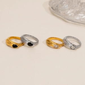 Elegant 18k gold and silver snake rings featuring teardrop gemstones and scaled texture