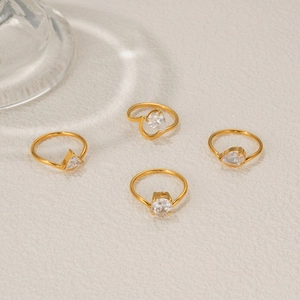 Macro detail of four-piece 18k gold plated ring set with various zircon stone cuts