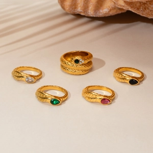 18K gold plated snake-shaped jewelry set with crystal stones on natural stone background
