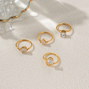 Set of four 18k gold plated rings with round, triangle, pear and heart zircon stones