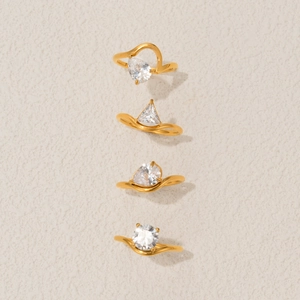Set of four 18k gold plated geometric rings featuring sparkling varied zircon stones