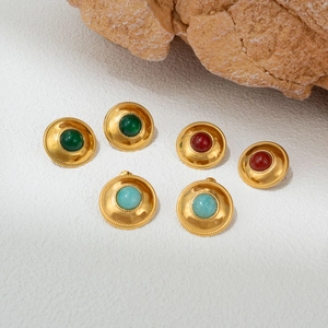 Detailed macro view of vintage 18k gold earrings with colorful round gemstone inlays