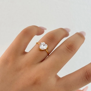 Detail of 18k gold plated ring featuring a large heart-shaped zircon on a thin band