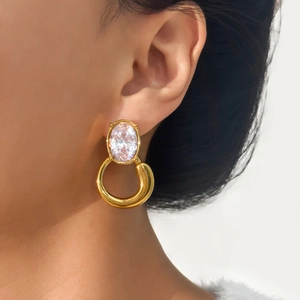 Elegant 18k gold plated titanium earrings with oval crystal gemstone on model