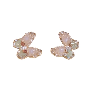 Pendientes de mariposa dorados con cristales facetados de colores sobre fondo blanco