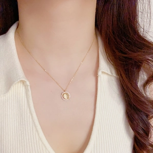 Close-up of elegant gold necklace with rotatable opal pendant and diamonds on model