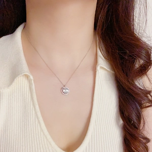 Close-up of cat eye stone necklace with crystal pendant on a silver chain neck wear