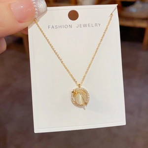 Rotating cat-eye stone pendant necklace with sparkling diamonds and gold star detail