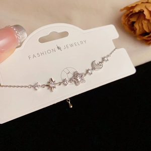 Detail view of silver star and moon bracelet with sparkling zircons and extension chain