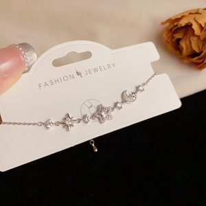 Sparkling star and moon charm bracelet with micro-p鑲 cubic zirconia on silver chain