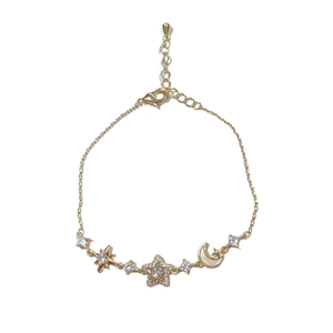 Elegant gold-tone star and moon link bracelet with shimmering pavé crystal accents