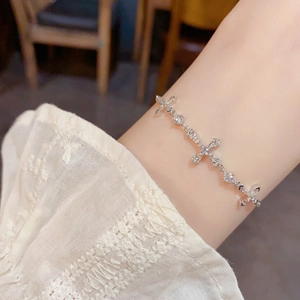 Elegant silver cross bracelet featuring sparkling zircons and adjustable pull-out clasp