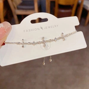 Detail of silver cross bracelet with cubic zirconia and adjustable sliding clasp
