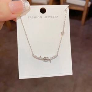 Close-up of knotted diamond smile necklace on fashion jewelry display card