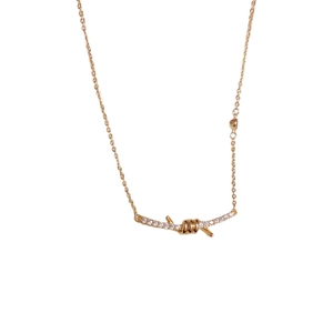 Elegant gold-plated knot necklace with sparkling stones and thorn design on a plain white background