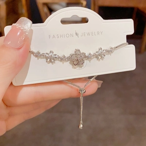 Detail of cherry blossom bracelet with zircon inlay and adjustable sliding clasp