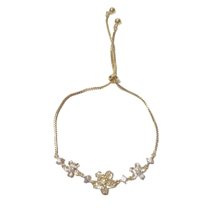Elegant gold flower bracelet with cherry blossoms and white crystals in adjustable pull design