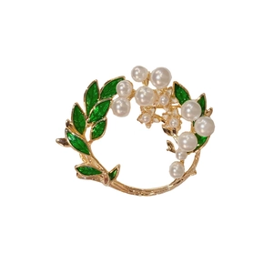 Elegant gardenia flower brooch with green enamel leaves and white pearls on gold base