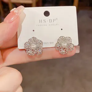 Detail of silver hollow flower earrings with S925 silver needle, pearls and zircon stones