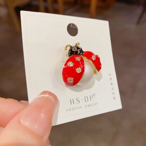 Unique ladybug brooch with red enamel and white pearls on a gold plated jewelry card