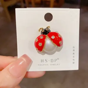 Detail of ladybug brooch featuring thickened real gold plating and pearl abdomen