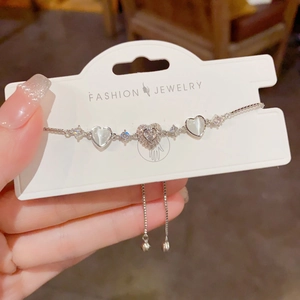 Detail view of heart-shaped zircon bracelet with adjustable slider clasp and beads
