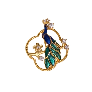 Exquisite hollow peacock brooch with blue enamel and crystal flowers in gold frame