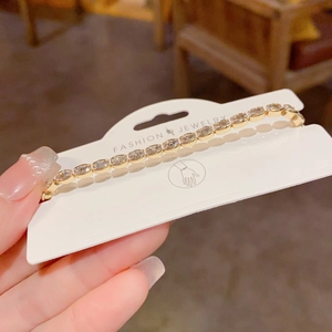 Elegant gold-plated tennis bracelet featuring oval-cut cubic zirconia and claw setting