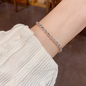 Close-up of a silver rhinestone bracelet with oval clear stones on a female wrist