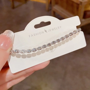 Detail of marquise-cut crystal tennis bracelet in silver finish on jewelry card