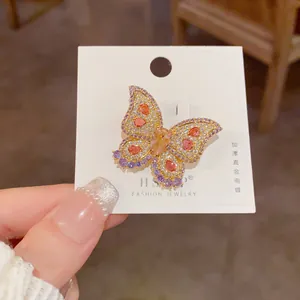 Detailed close-up of butterfly brooch with colorful zircons and thick real gold plating