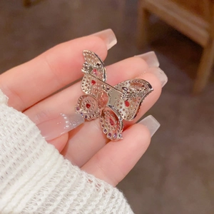 Exquisite silver-tone butterfly brooch with pink micro-pave zirconia stones held in hand