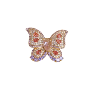 Elegant gold butterfly brooch with pavé zircon, pink orange and purple gemstones