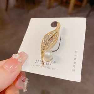 Elegant leaf brooch with zircon pave and white pearl accent on a presentation card