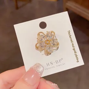 Exquisite gold floral brooch with micro-paved cubic zirconia petals and real gold plating