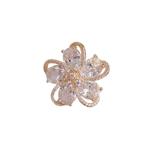 French luxury gold flower brooch with pear-cut cubic zirconia and micro-paved petals