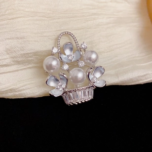Detail of silver flower basket brooch with pearls, blue enamel petals and zircons