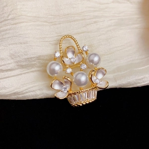 Elegant gold flower basket brooch with pearls, white enamel flowers and sparkling crystals