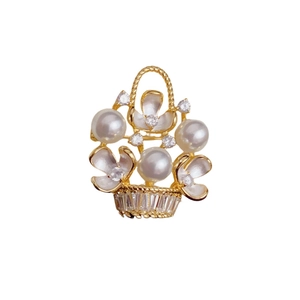 Elegant gold flower basket brooch featuring white pearls and shimmering crystal accents