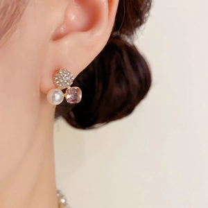 Nahaufnahme eleganter Ohrstecker mit Perle, rosa Kristall und Zirkonia-Besatz in Gold