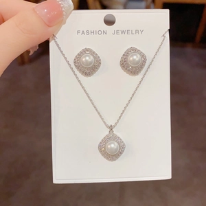 Elegant rhodium-plated jewelry set with rhombus pearl pendants and pavé zircon stones