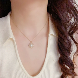 Luxe gold necklace with diamond-encrusted rhombic pearl pendant worn by model