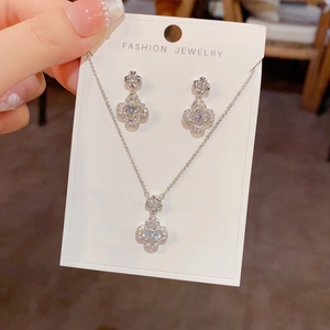 Detail of silver clover jewelry set with sparkling micro-pave cubic zirconia crystals