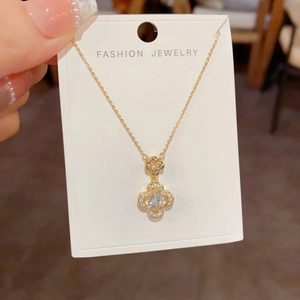 Detail of clover pendant necklace featuring double-layered micro-pave cubic zirconia crystals