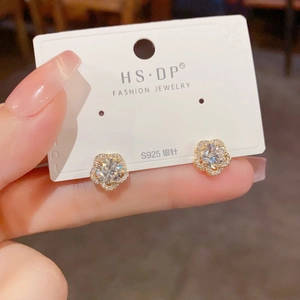 Détail de boucles d'oreilles fleur avec tiges en argent S925 et zircons brillants