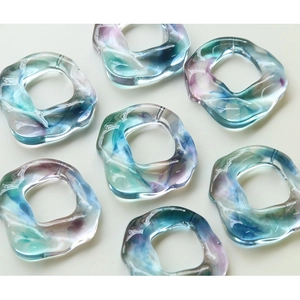 Colorful translucent resin irregular rings with blue purple pink swirling ink patterns