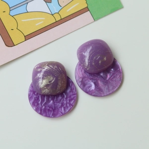 Chic purple acrylic earrings with gold swirl texture and marble effect details