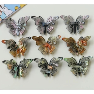 Top view of nine vintage acetate butterfly charms for DIY jewelry and hair accessories